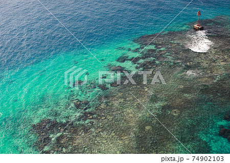 Red warning navigational tower stands near the coastline Red warning navigational tower stands near the coastline 74902103