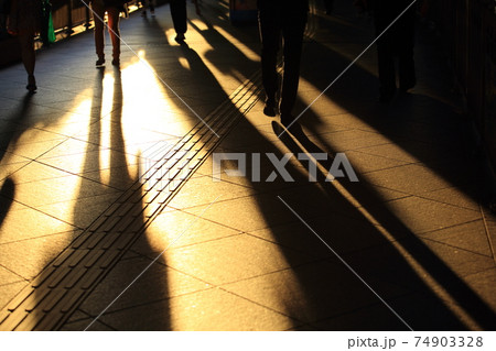 urban scenes: shadow of walking motion, pedestrian in the financial area at Hong Kong under sunshine 74903328
