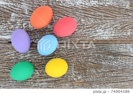 Easter eggs on wooden background with space Easter eggs on wooden background with space 74904386