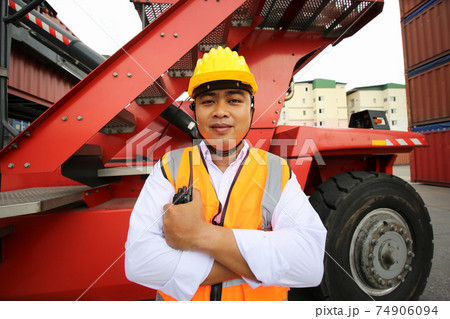 Foreman control loading Containers box from Cargo freight ship for import export. Container Warehouse Worker. 74906094