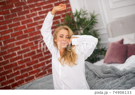 Woman in white shirt with closed eyes 74906133