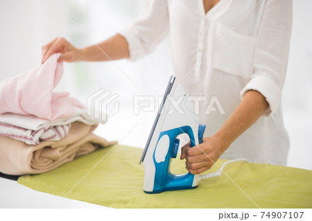 Close up picture of iron and clothes for ironing Close up picture of iron and clothes for ironing 74907107
