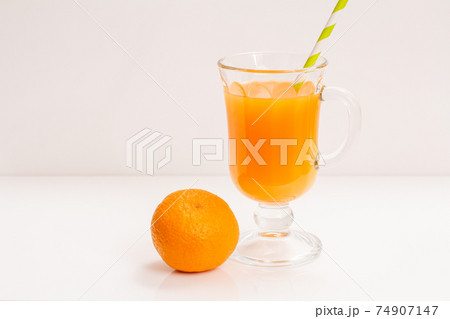 Fresh tropical fruits and glass of juice on white background. Fresh tropical fruits and glass of juice on white background. 74907147
