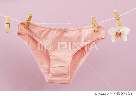 Beautiful women's cotton panties on lilac background. Beautiful women's cotton panties on lilac background. 74907218