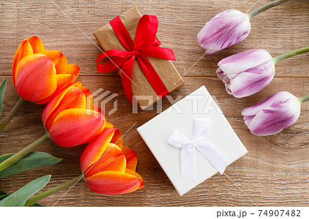 Gift boxes with ribbons on wooden boards. Gift boxes with ribbons on wooden boards. 74907482