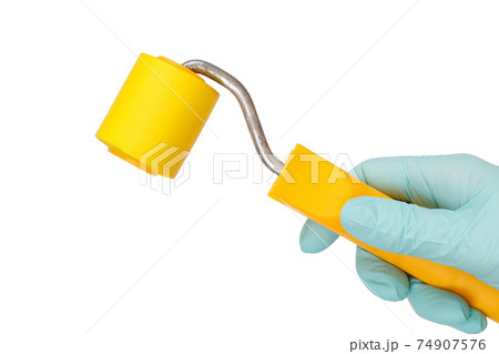 Woman holding roller on a white isolated background. Repair tool. 74907576