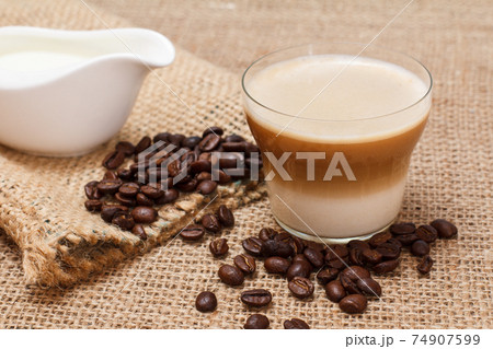 Coffee cappuccino and coffee beans on sackcloth 74907599