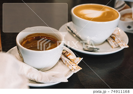 Two cups of different coffee on rustic wooden table. Symbolic image. Copy space Two cups of different coffee on rustic wooden table. Symbolic image. Copy space 74911168