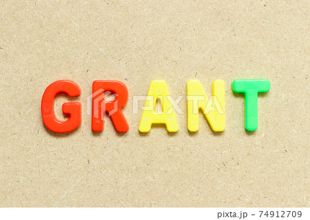 Color alphabet letter with word grant on wood background Color alphabet letter with word grant on wood background 74912709