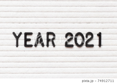 Black color letter in word year 2021 on white felt board background Black color letter in word year 2021 on white felt board background 74912711