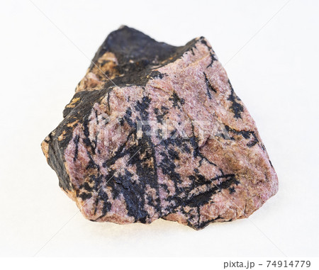 raw rhodonite stone on white 74914779