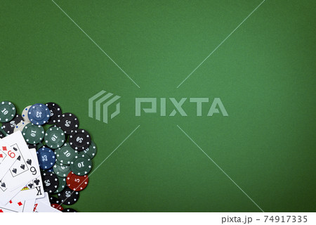 Cards and poker chips on a green background 74917335