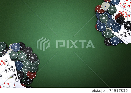 Cards and poker chips on a green background 74917336