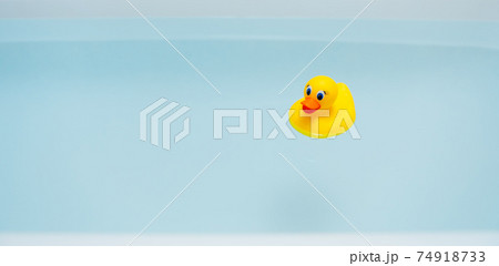 yellow rubber duck in blue water of bathtub yellow rubber duck in blue water of bathtub 74918733