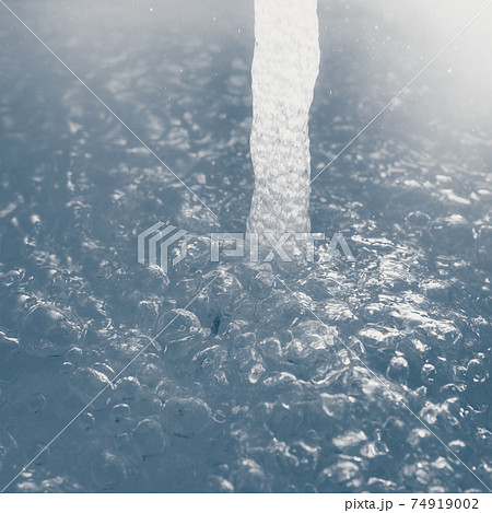 water stream with bubbles, closeup view water stream with bubbles, closeup view 74919002