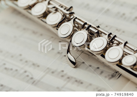 transverse flute on music sheet transverse flute on music sheet 74919840