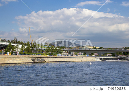 Floating bridge of Zaryadye park on Moskvoretskaya Embankment of Moskva River in Moscow, Russia. Shooting from a tourist pleasure boat Floating bridge of Zaryadye park on Moskvoretskaya Embankment of Moskva River in Moscow, Russia. Shooting from a tourist pleasure boat 74920888