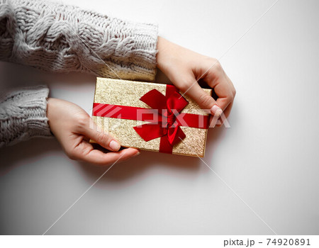 hands hold a gift on a white background hands hold a gift on a white background 74920891