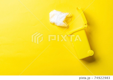Trash recycle. Bin container for disposal garbage waste and save environment. Yellow dustbin for recycle plastic trash isolated on yellow background. Trash recycle. Bin container for disposal garbage waste and save environment. Yellow dustbin for recycle plastic trash isolated on yellow background. 74922983