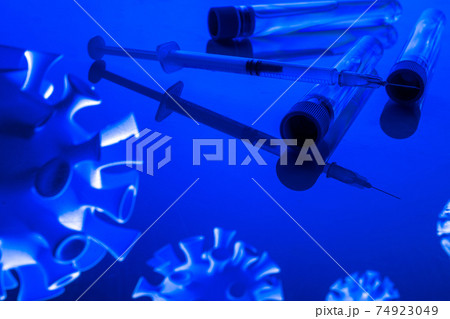 Vaccination bottle. Medical syringe with needle for protection flu virus and coronavirus. Covid vaccine on blue. Concept: diseases, medical care, science. 74923049