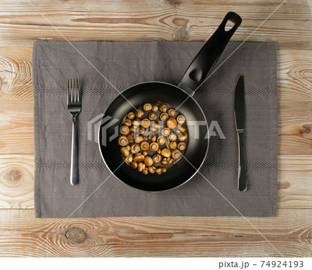 Whole Fried Small Champignons in Frying Pan Top View 74924193