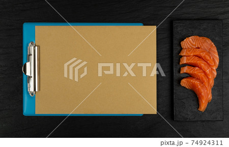 Slices of Raw Salmon Fillet on Black Background Mockup Top View Slices of Raw Salmon Fillet on Black Background Mockup Top View 74924311