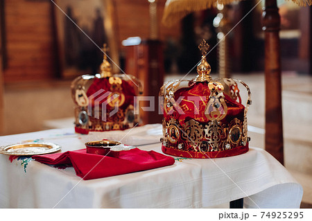 Two beautiful crowns with gold and red cloth stand 74925295