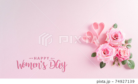 Happy Women's Day concept. Top view of roses flowers, heart and "Happy Women's Day" text on pink pastel background. 74927139