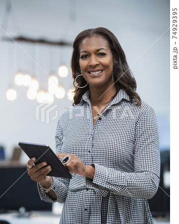 Portrait of business woman holding digital tablet 74929395