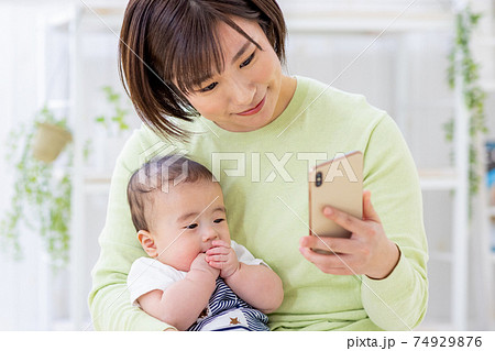 スマホを見る赤ちゃんとママ 74929876