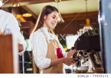 Asian Barista preparing cup of coffee, espresso with latte or cappuccino for customer order in coffee shop,making espresso, Small business owner and startup in coffee shop and restaurant concept. Asian Barista preparing cup of coffee, espresso with latte or cappuccino for customer order in coffee shop,making espresso, Small business owner and startup in coffee shop and restaurant concept. 74930173