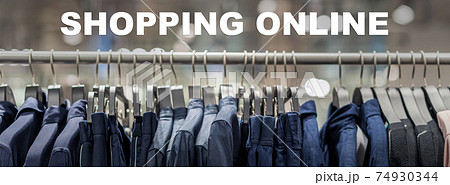 Shopping online text over Banner, web page of clothes rack in glasses fashion shop at shopping department store for display, copy space and paranomic ratio, business fashion and advertisement concept Shopping online text over Banner, web page of clothes rack in glasses fashion shop at shopping department store for display, copy space and paranomic ratio, business fashion and advertisement concept 74930344