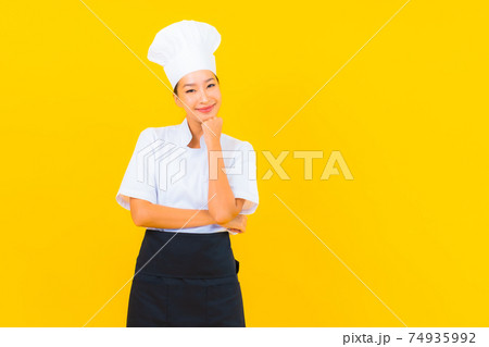Portrait beautiful young asian woman in chef or cook uniform with hat Portrait beautiful young asian woman in chef or cook uniform with hat 74935992