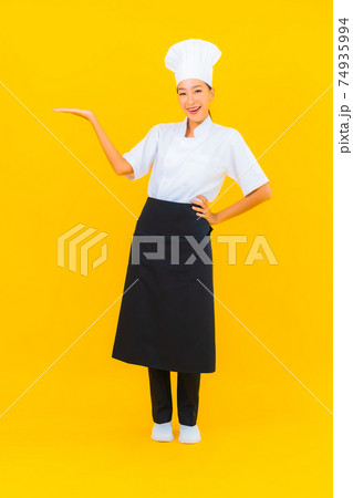 Portrait beautiful young asian woman in chef or cook uniform with hat Portrait beautiful young asian woman in chef or cook uniform with hat 74935994