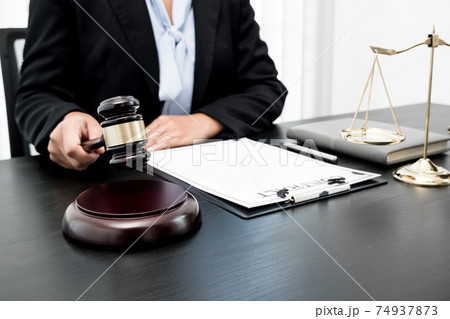 Professional women lawyers work at a law office There are scales, Scales of justice, judges gavel, and litigation documents. Concepts of law and justice 74937873