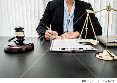 Professional women lawyers work at a law office There are scales, Scales of justice, judges gavel, and litigation documents. Concepts of law and justice 74937874