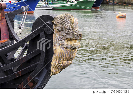Decorative figure of a lion on the prow of an ancient sailboat at Bermeo in the Basque Country, Spain 74939485