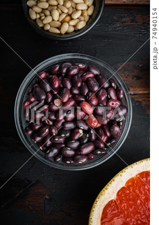 Red beans in bowl with healthy food, flat lay on dark wooden background Red beans in bowl with healthy food, flat lay on dark wooden background 74940154