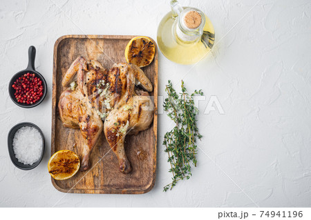Homemade roasted chicken, on white background, top view with copy space for text Homemade roasted chicken, on white background, top view with copy space for text 74941196