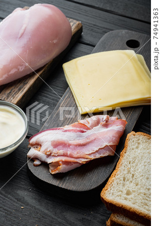 Club sandwich with fresh ingredients, on black wooden background 74941363