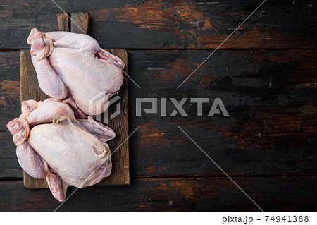Raw organic uncooked whole chicken, on old wooden table, top view with copy space for text Raw organic uncooked whole chicken, on old wooden table, top view with copy space for text 74941388