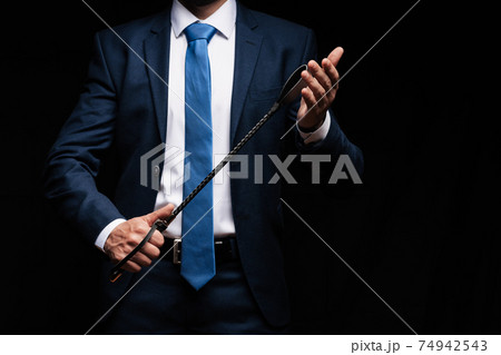 male dominant holds a leather whip Flogger for hard BDSM sex male dominant holds a leather whip Flogger for hard BDSM sex 74942543