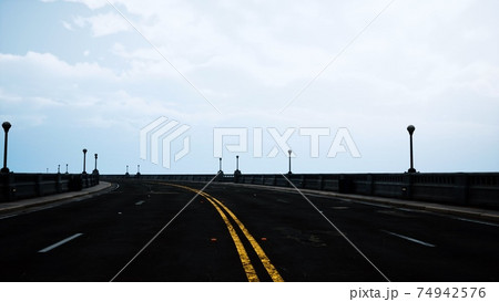 long bridge in misty fog 74942576