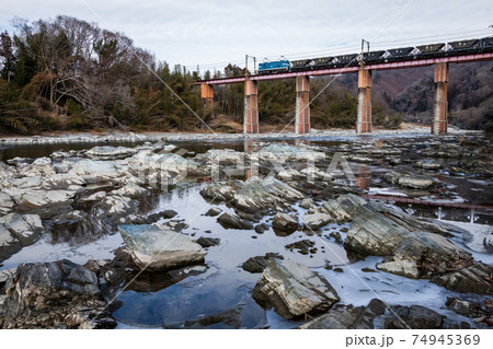 曇天の中、川を駆け抜ける秩父鉄道の電気機関車 74945369