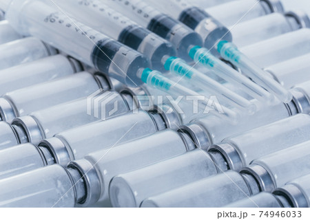 Medicine, Injection, vaccine and disposable syringe, drug concept. Sterile vial medical syringe needle. Glass medical ampoule vial for injection. 74946033