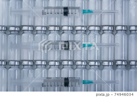 Medicine, Injection, vaccine and disposable syringe, drug concept. Sterile vial medical syringe needle. Glass medical ampoule vial for injection. Medicine, Injection, vaccine and disposable syringe, drug concept. Sterile vial medical syringe needle. Glass medical ampoule vial for injection. 74946034