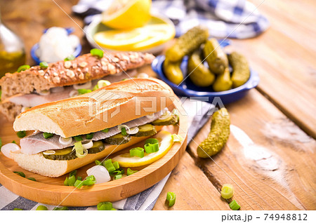 Dutch herring. Toast with Dutch herring, onions, pickles. Dutch herring. Toast with Dutch herring, onions, pickles. 74948812