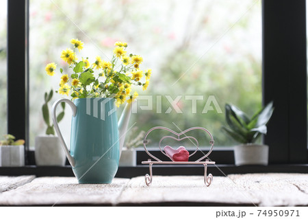 Teal tea pot with yellow Chrysanthemum inside and pink miniature heart chair Teal tea pot with yellow Chrysanthemum inside and pink miniature heart chair 74950971