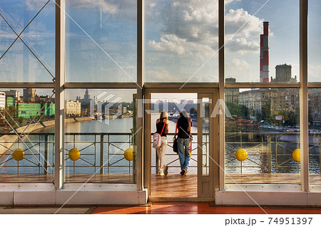 Two young people look at the city  74951397