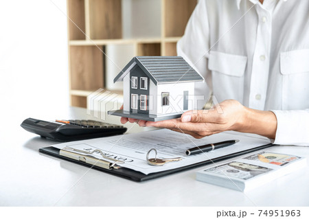 Image of Real estate broker agent sending house model to client after approve, home model mortgage loan offer for and house insurance 74951963